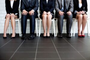 People in corporate attire sitting on chairs